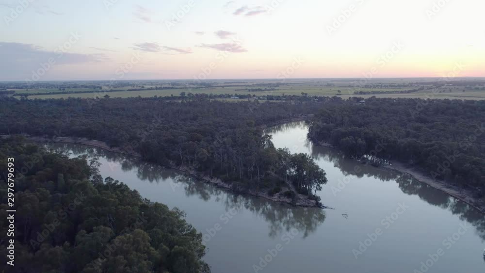 Forward flight over Murray River bend at sunset in Moama, NSW, Australia Forward flight over Murray River bend at sunset in Moama, NSW, Australia