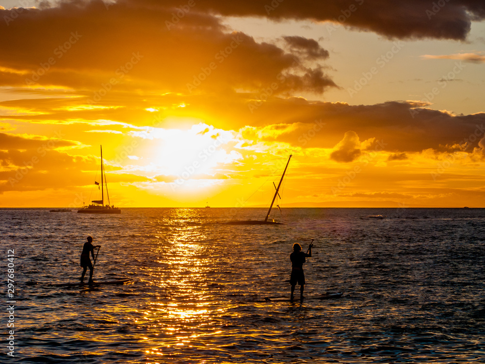 Fototapeta premium standup paddleboarders at sunst