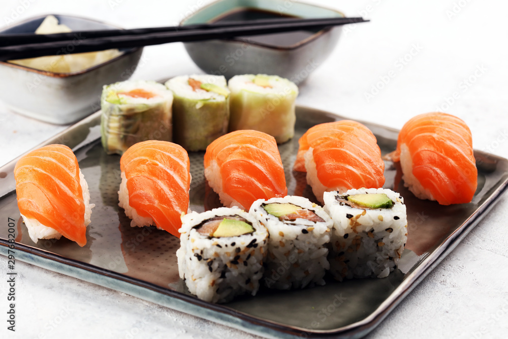 close up of sashimi sushi set with chopsticks and soy - sushi roll with salmon and sushi roll with smoked eel close up of sashimi sushi set with chopsticks and soy - sushi roll with salmon and sushi roll with smoked eel