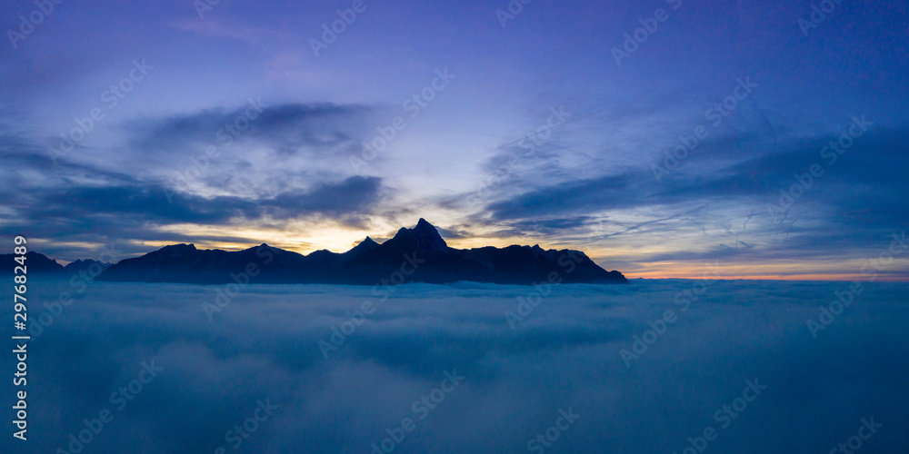 cloudy sunset panorama over clouds with view to mountain chain hahenkamm at reutte