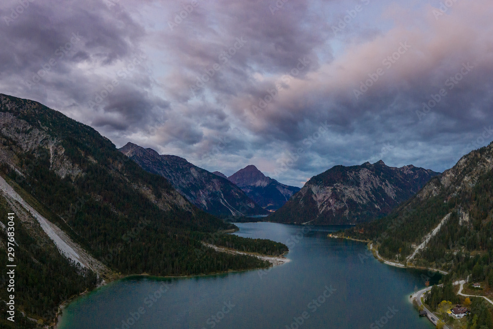 aerial view of dramatic cloudy sky over lake plansee at fall