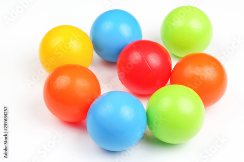 Colored plastic balls on white background © photosaint