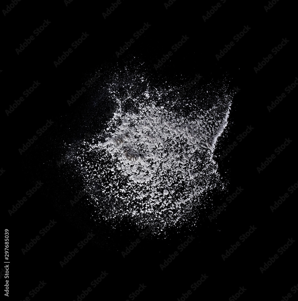 White solt powder explosion, flying pepper on black background, Freeze motion photo