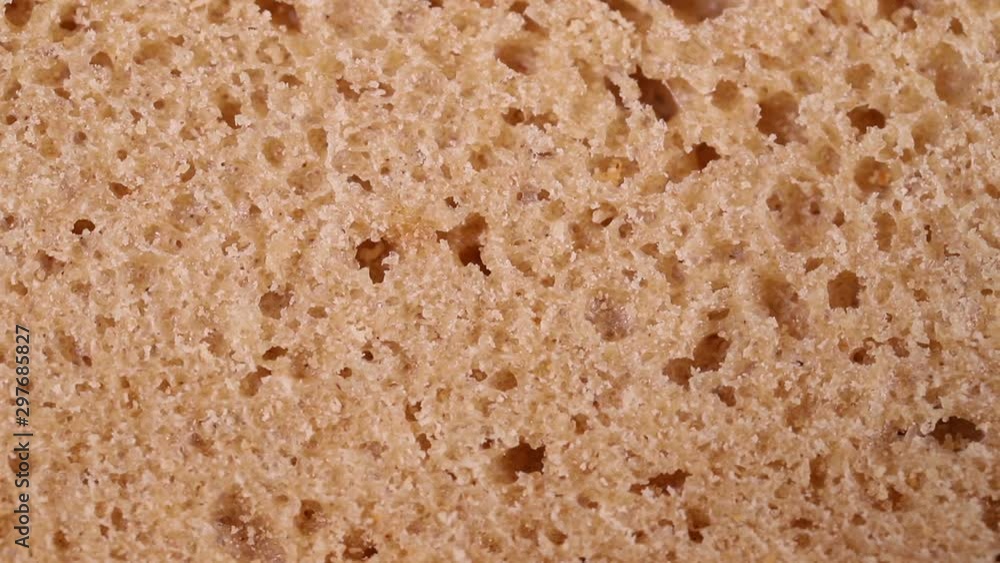 the crumb of bread rotates slowly. macro background the crumb of bread rotates slowly. macro background