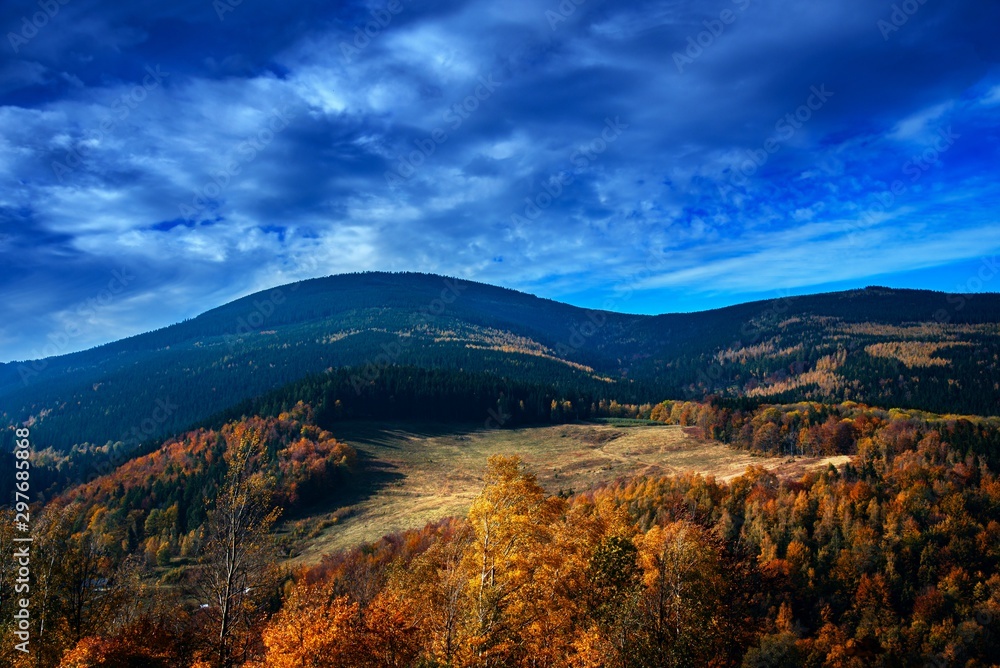 Mountains Karkonosze in Poland . Go to the target . In autumn view from mountain peaks . Amazing scene on autumn mountains. Yellow and orange trees in fantastic morning sunlight.   Scenic view of moun