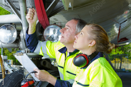 Fotografie airport workers check an aircraft for safety