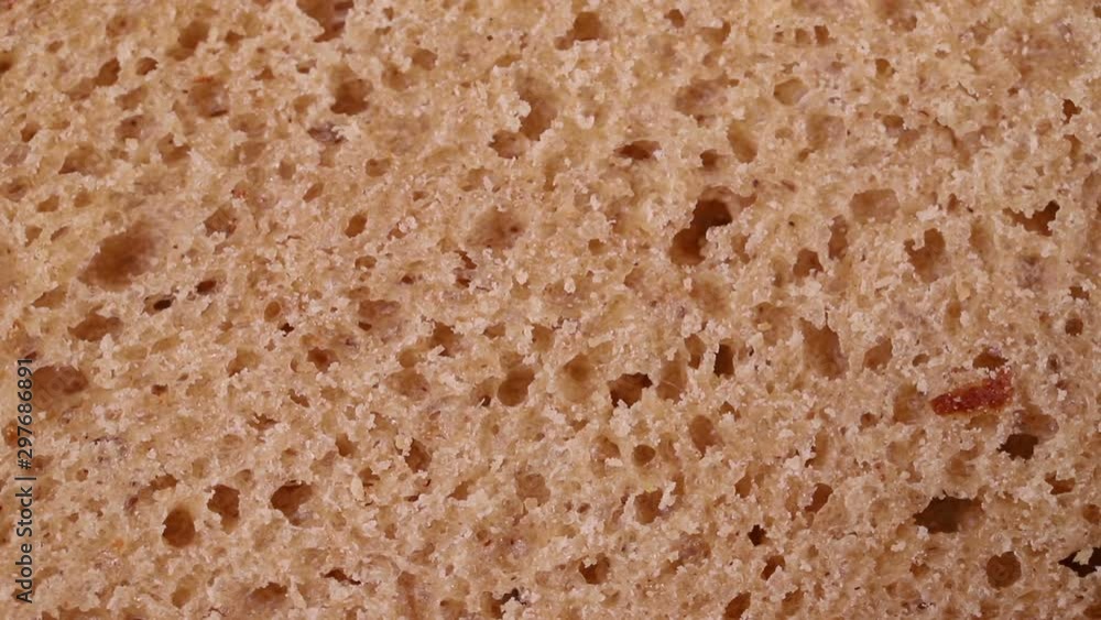 the crumb of bread rotates slowly. macro background the crumb of bread rotates slowly. macro background