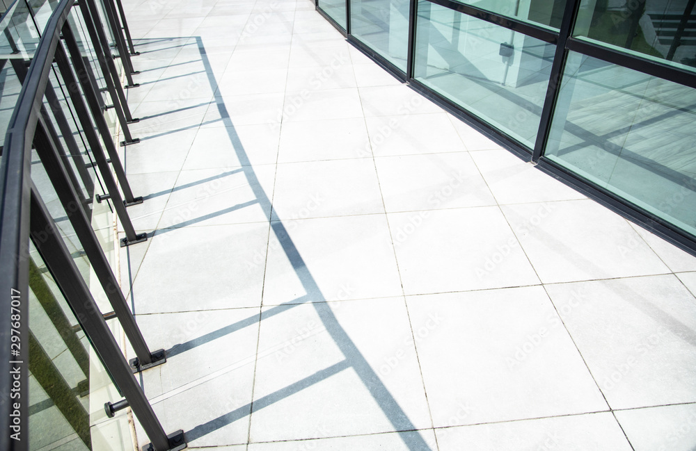 white tile floor background outdoor modern office building exterior construction view with shadow from small decoration fence white tile floor background outdoor modern office building exterior construction view with shadow from small decoration fence