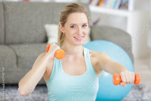 fitness woman with dumbbells at home