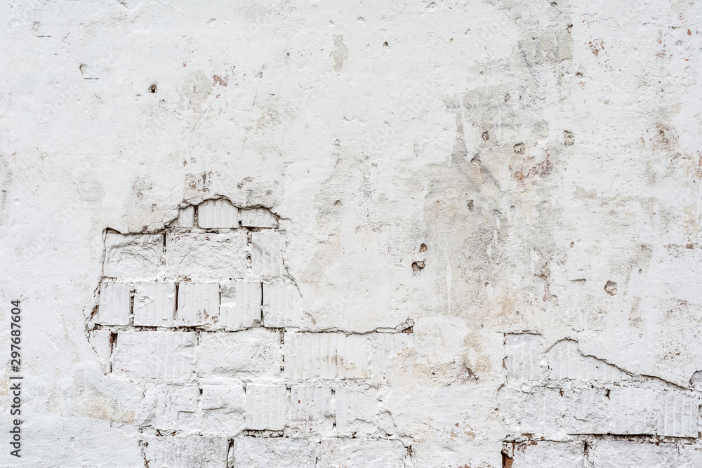 texture of a white wall with a damaged stucco layer, architecture abstraction background