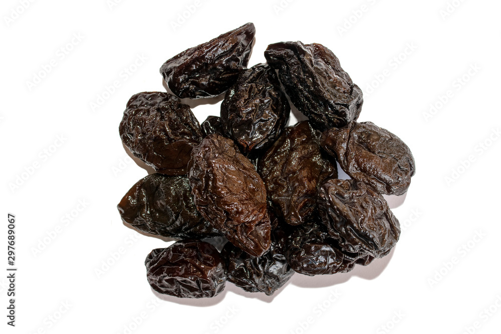 Prunes. Fresh black dried prunes isolated on white background. Pile of dried prunes. Top view Prunes. Fresh black dried prunes isolated on white background. Pile of dried prunes. Top view