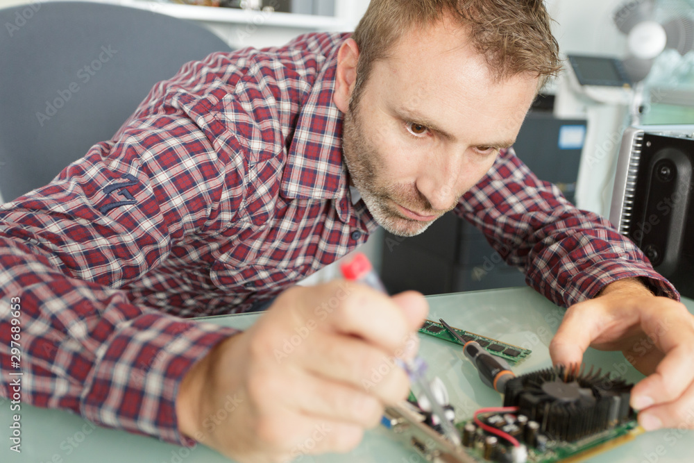 man fixing electronics man fixing electronics