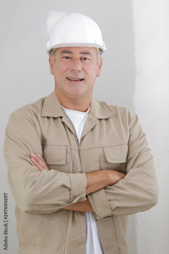 portrait of young architect standing with arms crossed and smiling