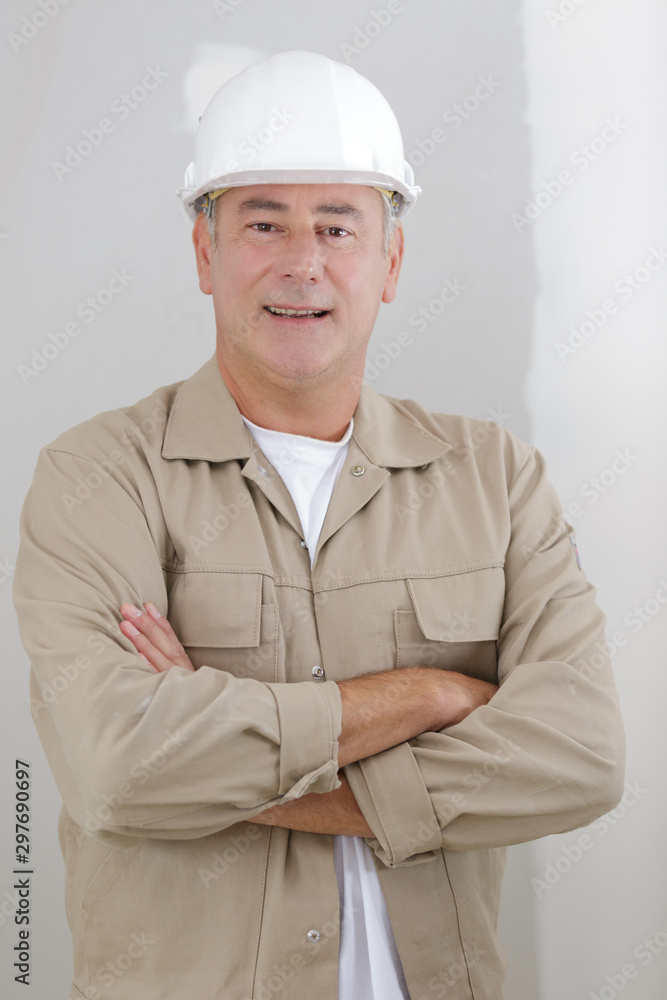 portrait of young architect standing with arms crossed and smiling portrait of young architect standing with arms crossed and smiling