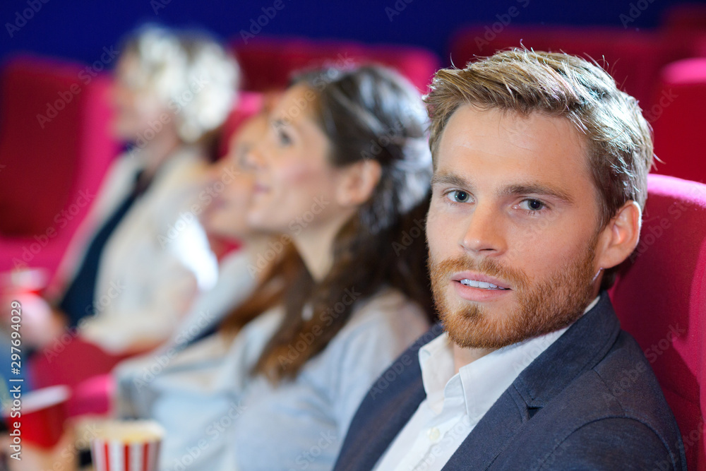 friends and couples watching interesting film at big cinema hall friends and couples watching interesting film at big cinema hall