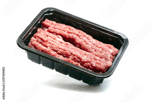 Ground beef in a black plastic tray isolated on white background. Uncooked mincemeat. Forcemeat, fresh raw minced meat photo