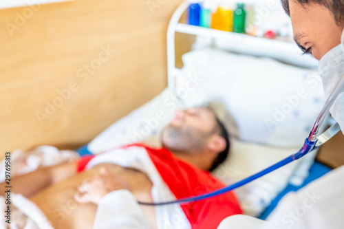 Arabic man feeling sick and being checked by the doctor