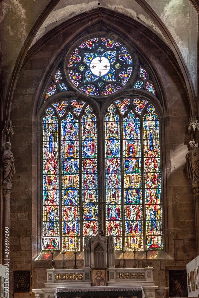 inside St. Faiths  church with colorful windows in Selestat