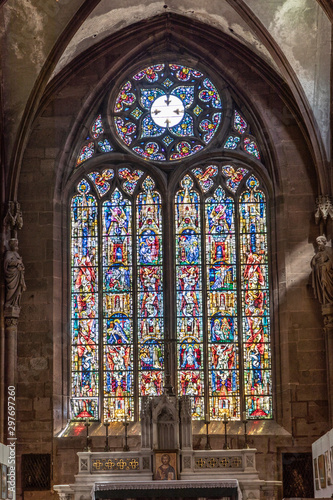 inside St. Faiths church with colorful windows in Selestat