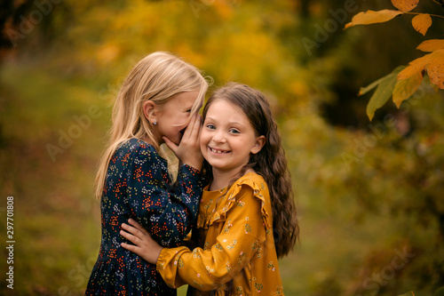 happy family, two sisters in the autumn park, girls smiling