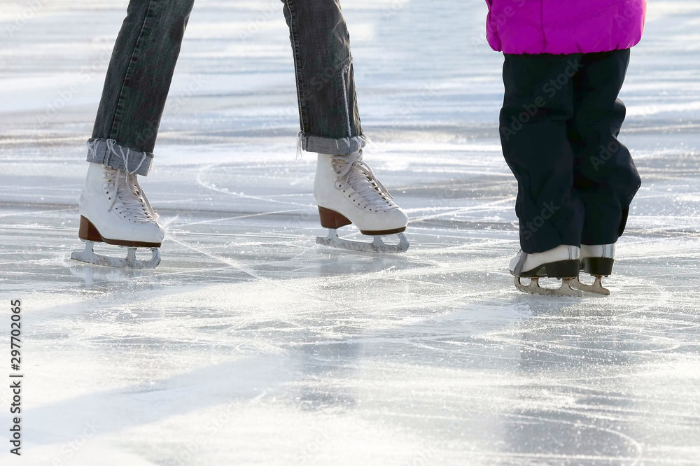 little girl with mother skate on the rink.. Sport and entertainment. Rest and winter holidays. little girl with mother skate on the rink.. Sport and entertainment. Rest and winter holidays.