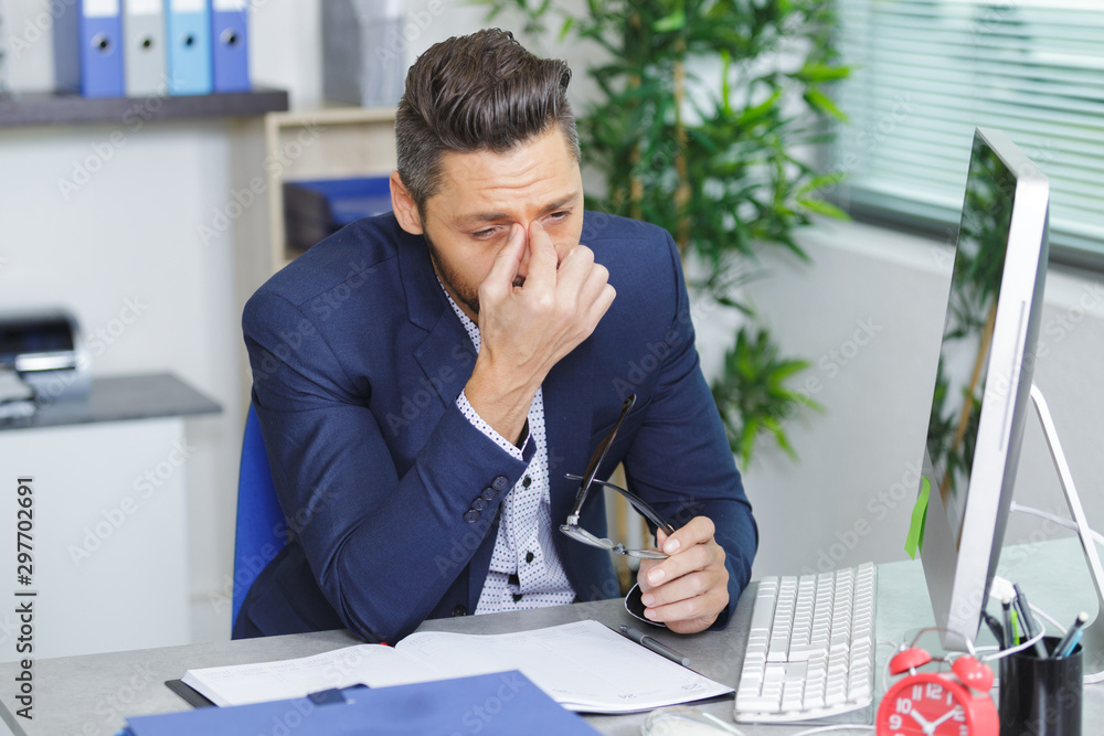 tired businessman with eyeglasses in office tired businessman with eyeglasses in office