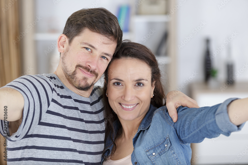 couple taking self portrait with smart phone couple taking self portrait with smart phone
