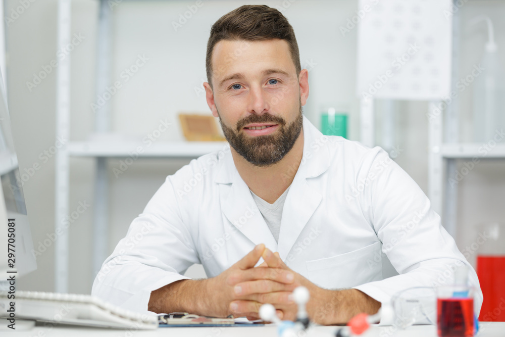 male chemist scientific reseacher using microscope in laboratory