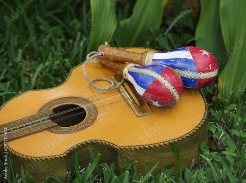 A cuban traditional tres, Cuba national folk guitar, together a couple of cuban maracas.
