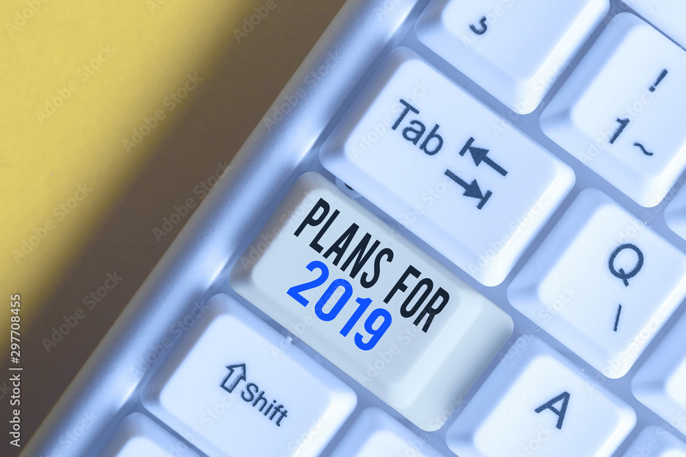 Writing note showing Plans For 2019. Business concept for an intention or decision about what one is going to do White pc keyboard with note paper above the white background