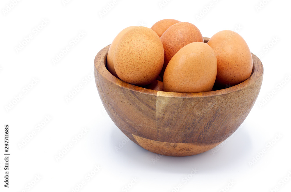 Fresh chicken eggs in a wooden bowl on a white background Fresh chicken eggs in a wooden bowl on a white background