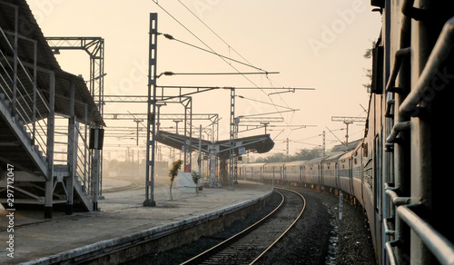 Indian railway train,at station platform,view from window at dawn,Tamil Nadu,India.
