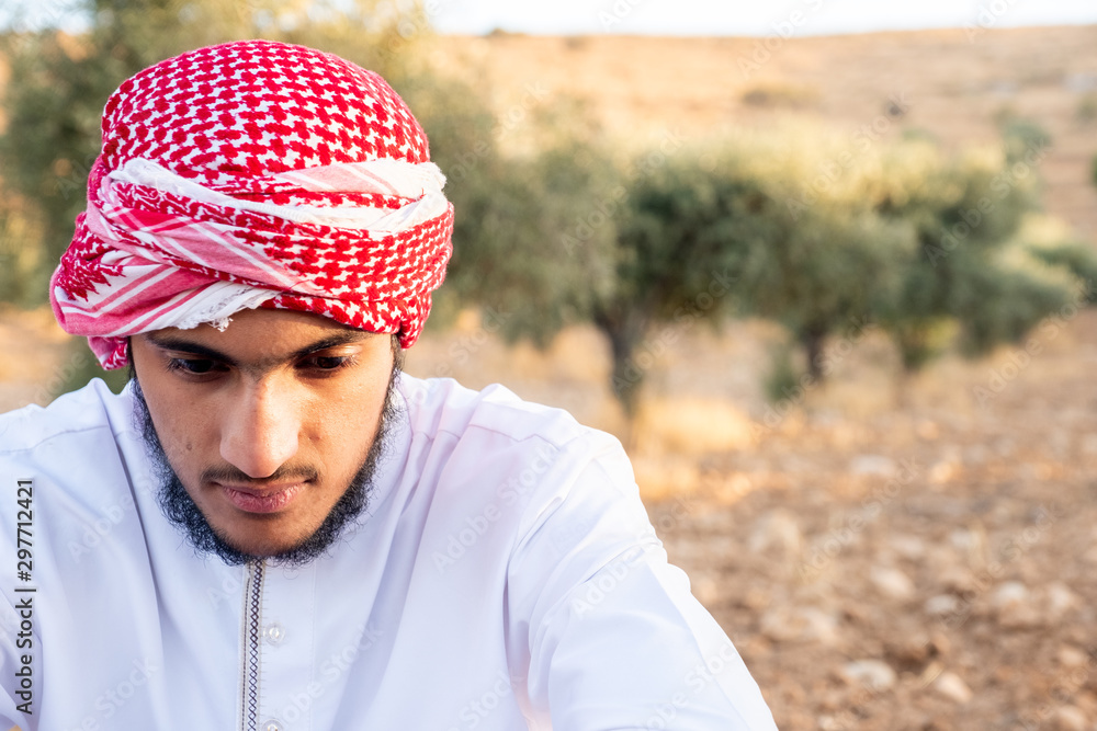 Muslim guy enjoying the weather and the sun in an olive farm Muslim guy enjoying the weather and the sun in an olive farm