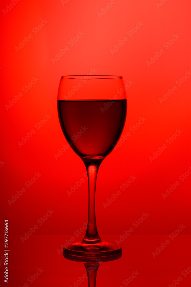 Wineglass with red wine close-up isolated on pink background Wineglass with red wine close-up isolated on pink background
