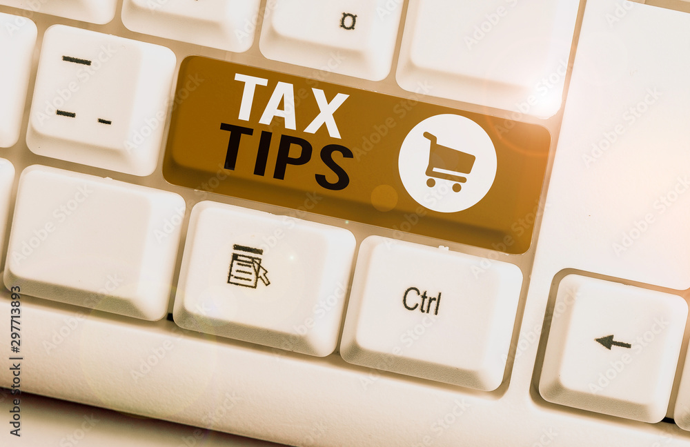 Word writing text Tax Tips. Business photo showcasing compulsory contribution to state revenue levied by government White pc keyboard with empty note paper above white background key copy space Word writing text Tax Tips. Business photo showcasing compulsory contribution to state revenue levied by government White pc keyboard with empty note paper above white background key copy space