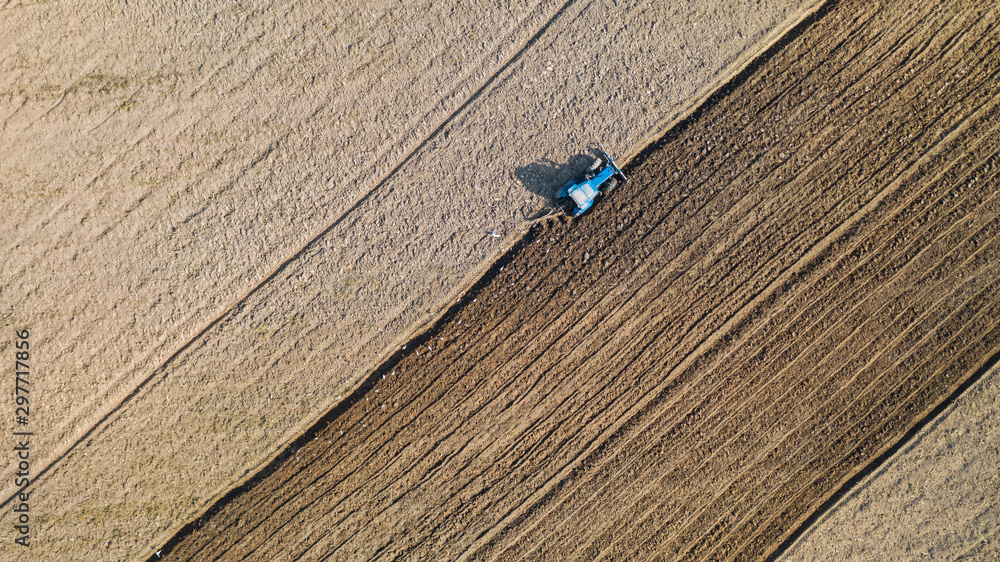 Top view of agricultural tractor vehicles working at field Top view of agricultural tractor vehicles working at field