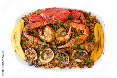 Top view of seafood with rice isolated in a white backgorund. Delicious ecuadorian dish with crab, shrimps, mussels, fried banana and rice. Studio shot seaman rice.