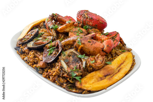 Seafood with rice isolated in a white backgorund. Delicious ecuadorian dish with crab, shrimps, mussels, fried banana and rice. Studio shot seaman rice.