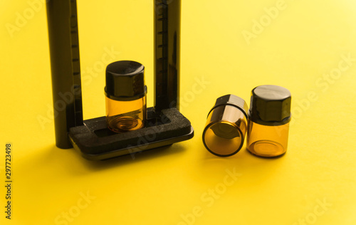 Composition of bottles for aroma, essential oil or medicine on a yellow background in other perspective. Soft focus in the middle..