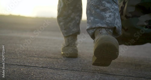 Slow Motion Military Army Boots Walking at Sunrise photo