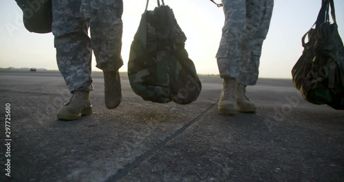 Slow Motion Military boots walking at sunrise photo