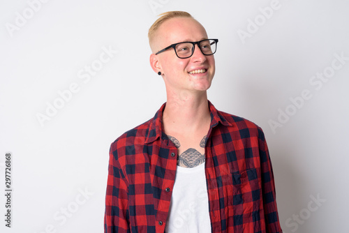 Face of happy young blonde hipster man thinking and looking up © Ranta Images