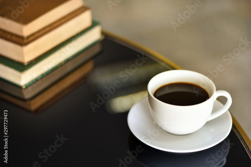 Black coffee in a white cup on a black glass table, Concept free time for thinking.