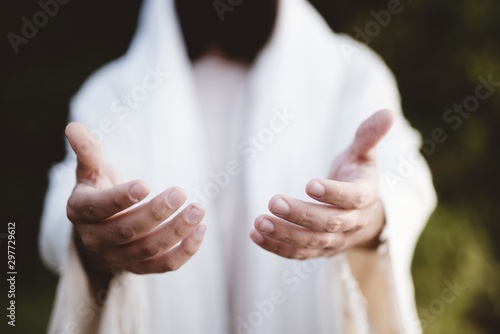 Closeup shot of Jesus Christ reaching out with a blurred background Fototapeta
