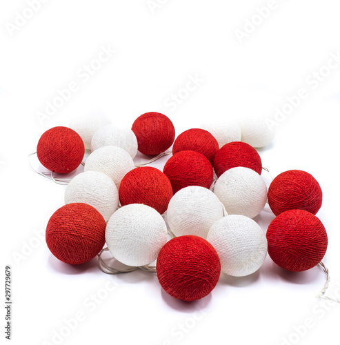 Red and White light ball  ornament for hanging on a festive Christmas tree or any festive event on a bright white background. Focus on the front. Holiday decorations for any festive events.  © Jirakit