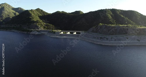 Aerial drone scene of dam and its lake, flying towards overflow structure. From panoramic to senital view. Nogoli, San Luis, Argentina.  photo