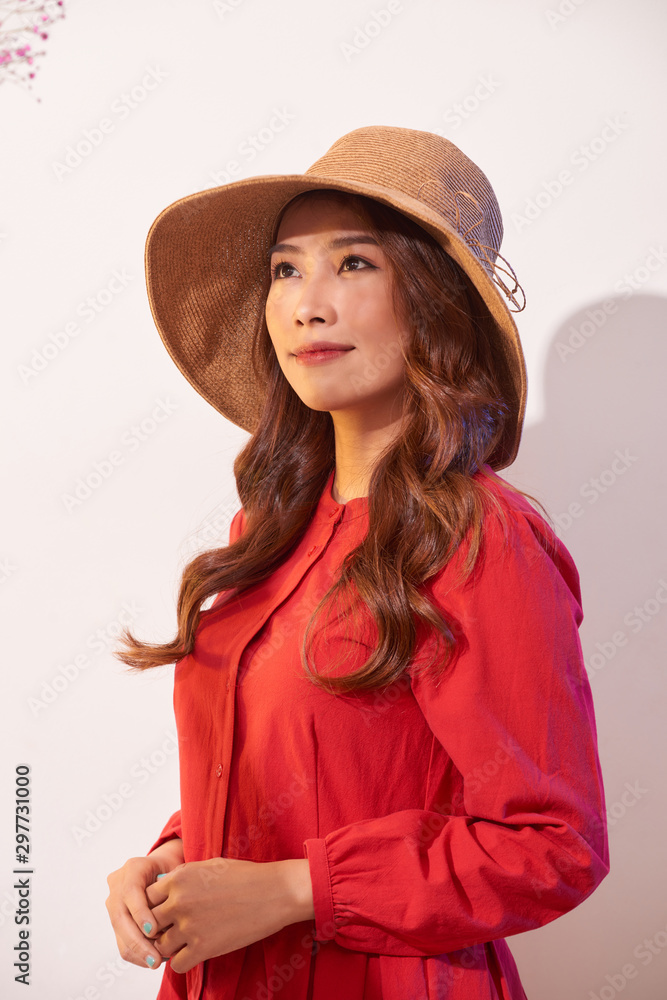 Happy thinking young woman looking up in straw hat on white background with empty copy space Happy thinking young woman looking up in straw hat on white background with empty copy space