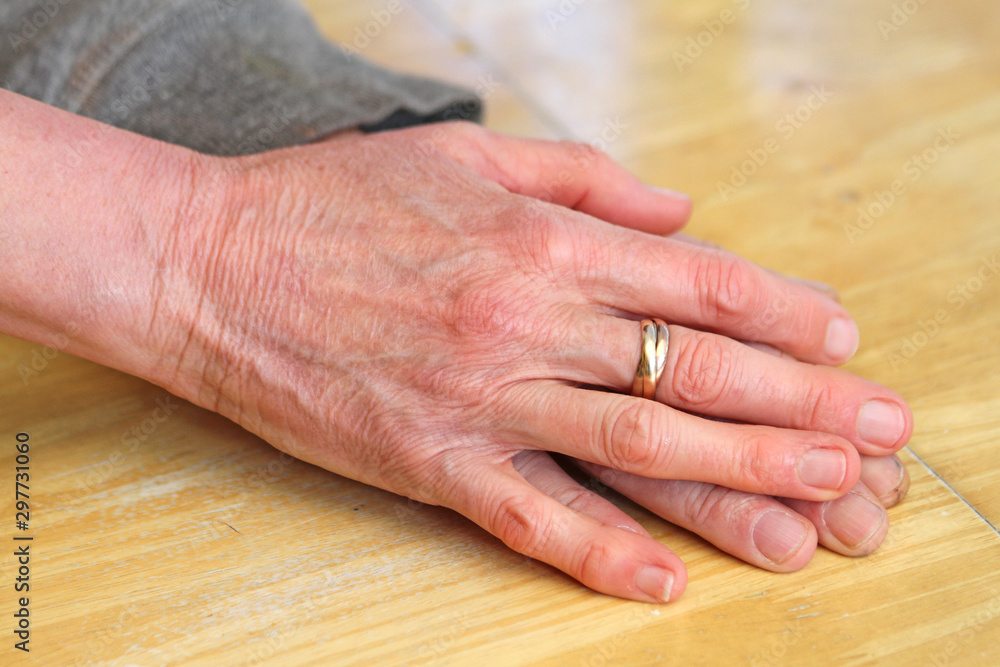 Two hands on top of each other with wedding ring. Man and woman couple hands love concept Two hands on top of each other with wedding ring. Man and woman couple hands love concept