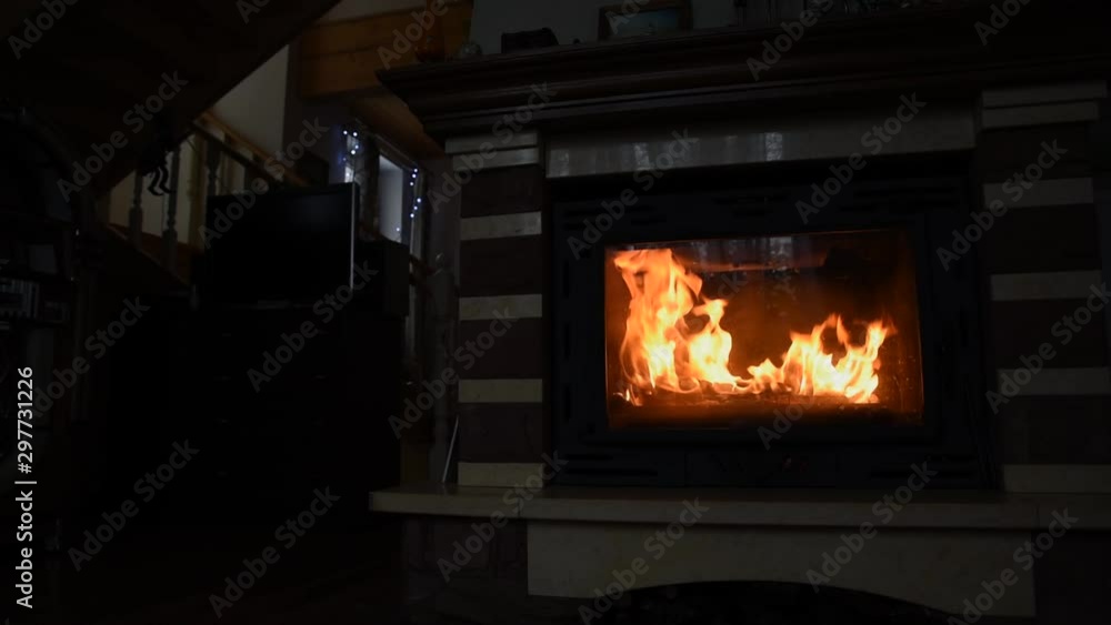 Burning fireplace with dancing glowing fire in a country house. Cozy Home Concept, Christmas and new year holidays, vacation, winter or autumn season. Burning fireplace with dancing glowing fire in a country house. Cozy Home Concept, Christmas and new year holidays, vacation, winter or autumn season.