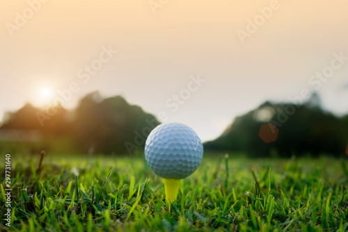 Golf ball on tee in beautiful golf course